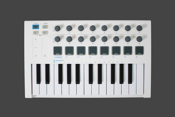 White midi keyboard with knobs and pads