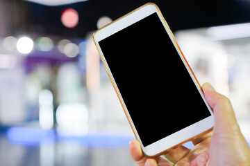 Digital Smartphone disruption concept, Hand holding mobile for searching information data internet at anywhere in office over blur background. Technology / internet of things for new generation