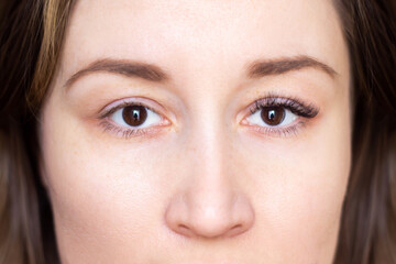 Cropped shot of a brown-eyed young brunette woman before and after eyelash extensions