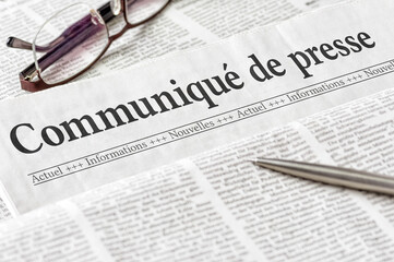 A newspaper with the headline Press Release in french - Communiqué de presse