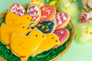 assortment of easter chick and egg cookies in a nest basket