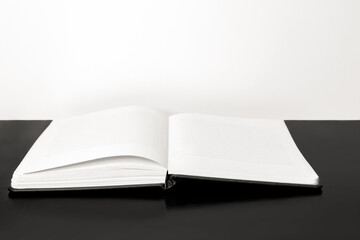 Opened notebook,  Black-white background.