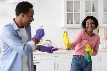 Cute black lovers shooting with cleaning sprays
