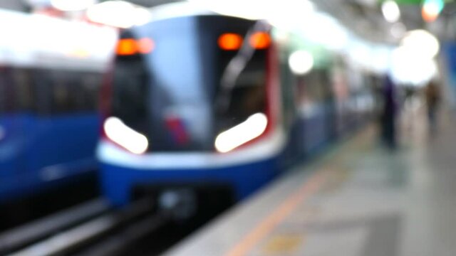 BTS sky train arriving to station and departure - Bangkok, Thailand. Defocused or blur shot.