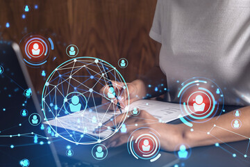 Fototapeta premium A potential employee signing the contract to boost her career and gain new opportunities in personal growth. Hiring a new talented crew. Social media hologram icons. Women in business concept.