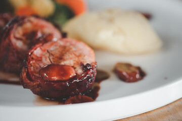 Pork tenderloin wrapped with bacon. Delicious healthy food served for lunch in restaurant