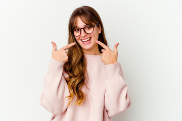 Young caucasian cute woman isolated on white background smiles, pointing fingers at mouth.
