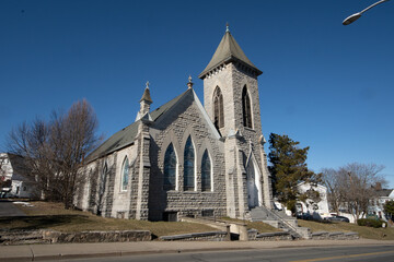 Middletown, NY - USA - Mar 13, 2021: View of the historic Christ Church or First Universalist Church of Middletown. Built in 1901. It has an offset bell tower and Tiffany glass memorial window.