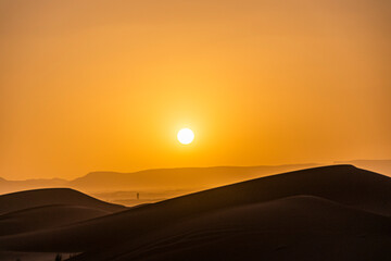 Sunset between sand dunes