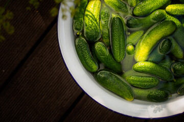 pickled gherkins in white bowl from above