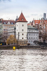 Fototapeta premium Prague, Czech republic - March 12, 2021. Historic building of Malostranska Water Tower (vodarna) by Moldau river
