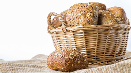 Rye bread. Bakery with crusty loaves and crumbs. Fresh loaf of rustic traditional bread with wheat grain ear or rye spike plant on natural cotton background. Healthy Food concept. - Powered by Adobe