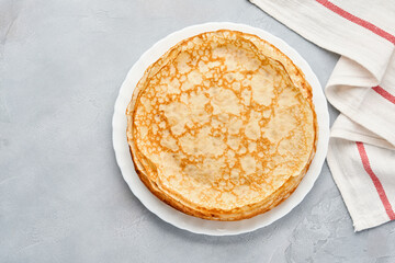 Crepes, thin pancakes on gray plate. Marble background. Copy space. Mock up. Top view