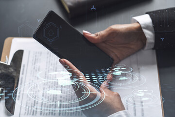 Businesswoman in formal wear checking the phone to sign the contract to create a software to present it at start up conference and gain investments for innovative service. Hologram tech graphs.