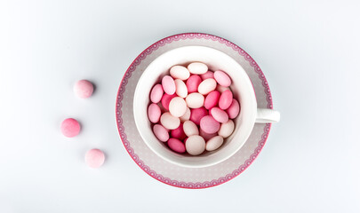 pink and white candy in a cup