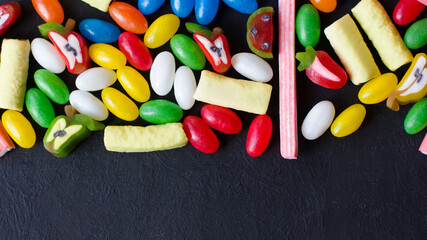Many colored sweets on a black background
