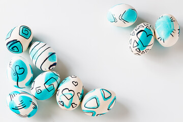 Creative trendy painted easter eggs on white background.