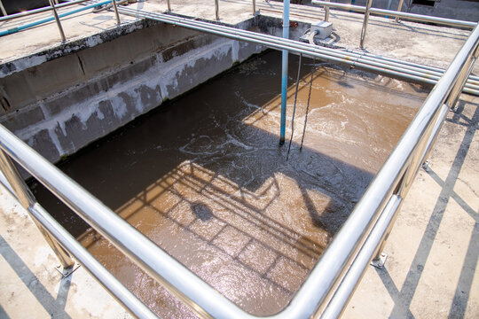 Sewage from drainpipe factory flowing to water treatment tank of waste-water plant. Activated sludge process system.