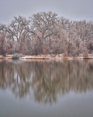 heavy snowstorm over small lake in northern Colorado, one of natural areas along the Poudre River  in Fort Collins