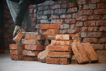 Bricklayer is laying a brick close up.