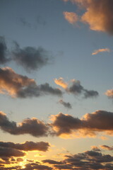 Evening Sky with Fluffy Colored Clouds and Sunset