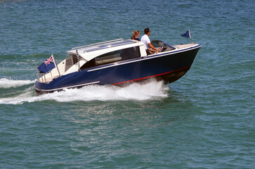 Fototapeta na wymiar High-end motor boat speeding on the Florida Intra-Coastal Waterway near Miami Beach.