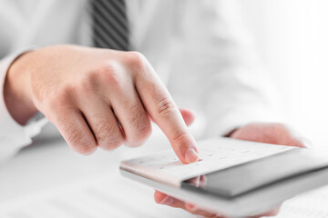 Businessman working with using a calculator to calculate the numbers. Finance accounting concept