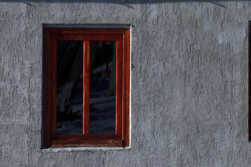 Wooden window on the wall of a house