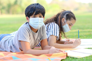 A half-Thai-Indian boy and a mixed-Thai-European girl friend wear face masks to prevent virus