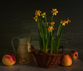 Floral arrangement in a wicker basket and ripe apples. Vintage.