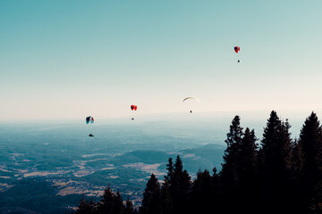 sports paragliding on a parachute over the countryside