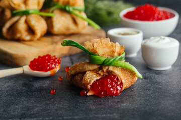 Pancakes with caviar. Pancake envelopes. Delicious pancakes on the table. 