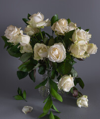 Still life with a bouquet of white withered roses. Vintage.