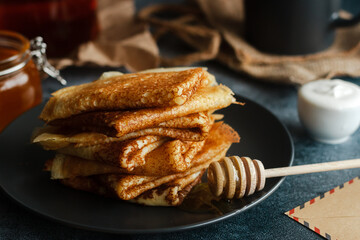 Delicious pancakes on a plate. Pancakes with honey