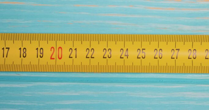 Roll of measuring tape in motion macro