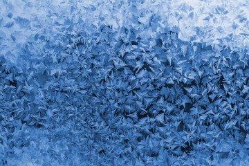 Fototapeta na wymiar Beautiful ice pattern on winter window