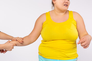 Physiotherapist working with fat female patient in clinic, Concept of healthcare for woman plus size overweight. Cropped photo on grey background