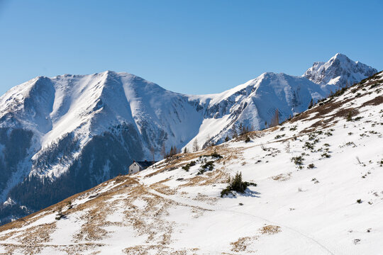 Leobner hut and snow-capped Eisenerzer Reichenstein in the background