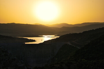Dam in the mountains at sunset