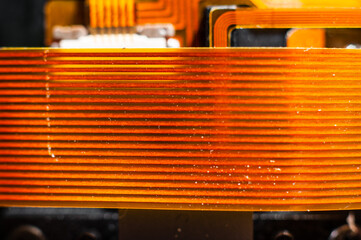 Board-to-board electronic loop of bright orange color for transferring information between...