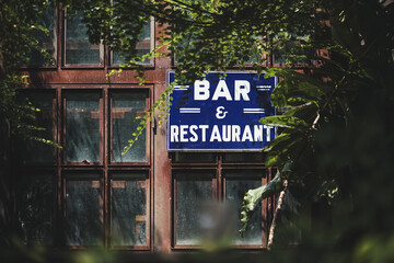 Bar and Restaurant. Windows with BAR & RESTAURANT sign in blue and white. Vignette and Vintage film...