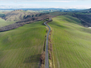 Fototapeta na wymiar road in the hills seen from the drone in spring