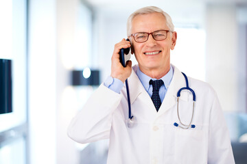 Male doctor having a call while standing in doctor's office