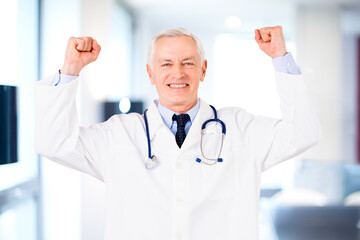  Doctor celebrating victory with raised hands