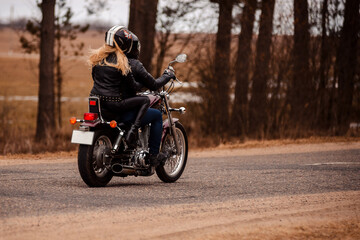 Fototapeta na wymiar Bikers husband and wife riding a motorcycle on the road