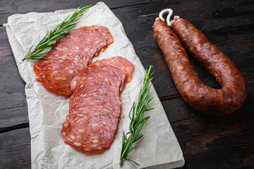 Chorizo, spanish traditional sausage cut to slices on old wooden table