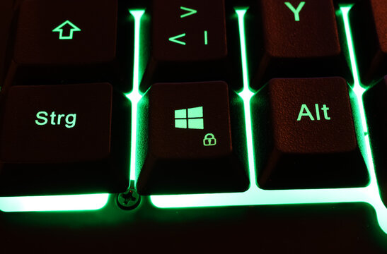 Macro closeup of green illuminated control, alt and windows keys on computer keyboard (focus on center of word alt)