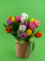 Bouquet of tulips. Flower delivery. Green background . Tulip.