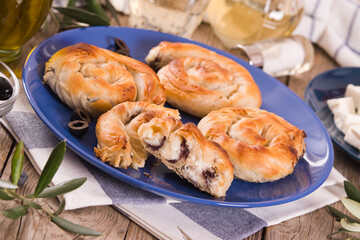 Pastry swirls with cheese and olive filling.