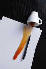 Coffee spilled on sheets of paper